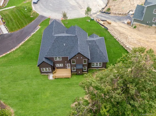 an aerial view of a house with outdoor space lake view and mountain view