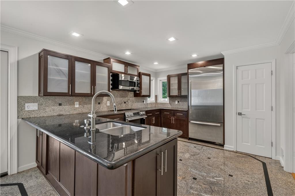 4610 West Morton Road Alpharetta, GA 30022 - Photo 14 of 53 a kitchen with stainless steel appliances granite countertop a sink a stove and a refrigerator