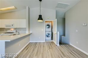 8777 Roping Rodeo Avenue, Unit 101 Las Vegas, NV 89178 - Photo 3 of 8 Seamlessly integrated laundry area and a modern kitchen create an inviting, functional living space.
