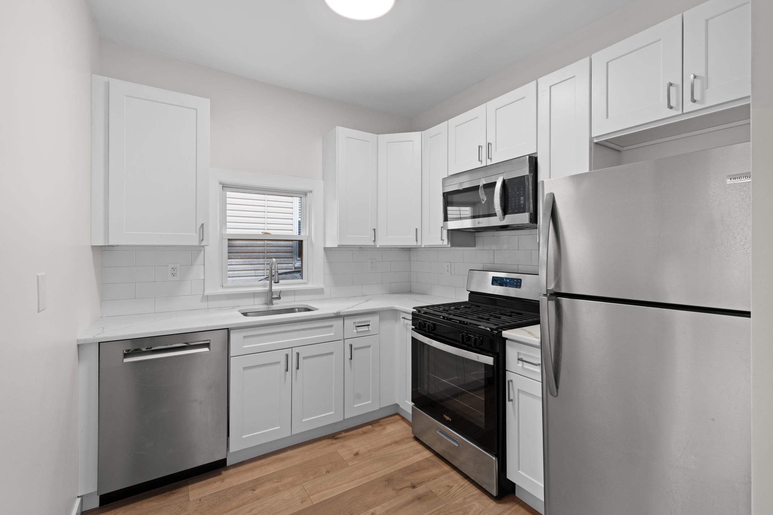 a kitchen with a sink stove and refrigerator