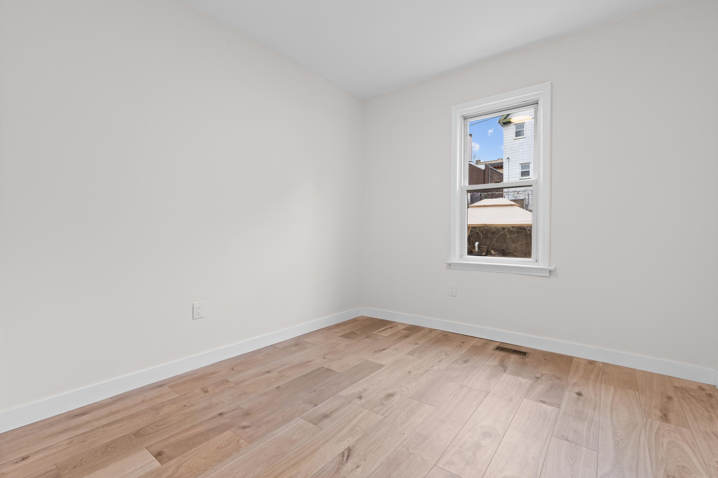 3 Edison Place, Unit 1 East Rutherford, NJ 07073 - Photo 13 of 21 an empty room with a window