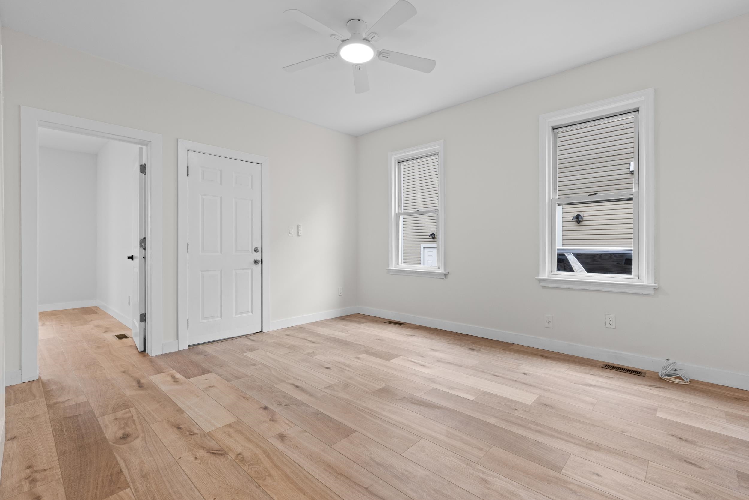 3 Edison Place, Unit 1 East Rutherford, NJ 07073 - Photo 16 of 21 a view of empty room with wooden floor and fan