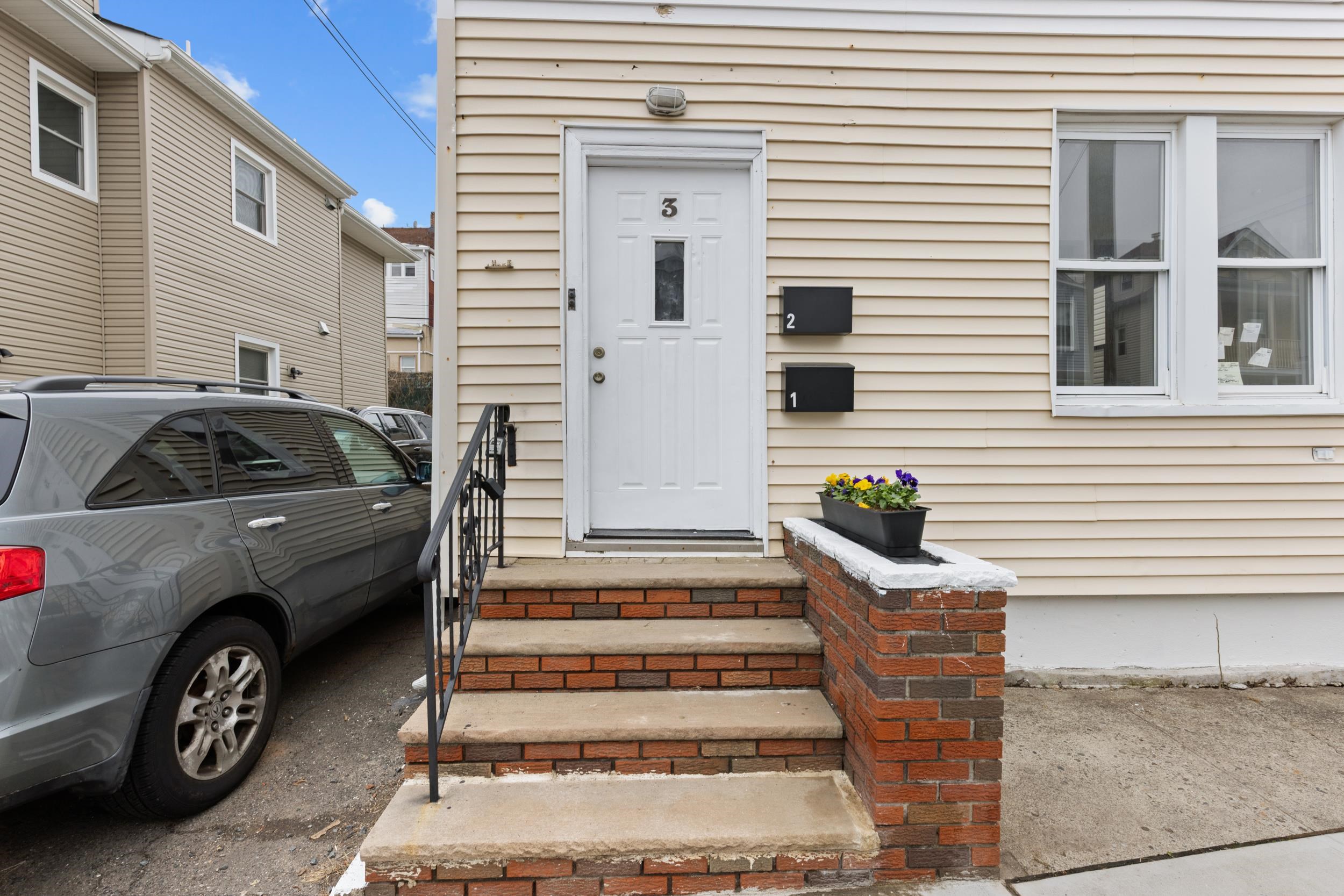 3 Edison Place, Unit 1 East Rutherford, NJ 07073 - Photo 18 of 21 a view of a car parked in front of a house