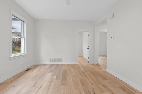 wooden floor in an empty room with a window