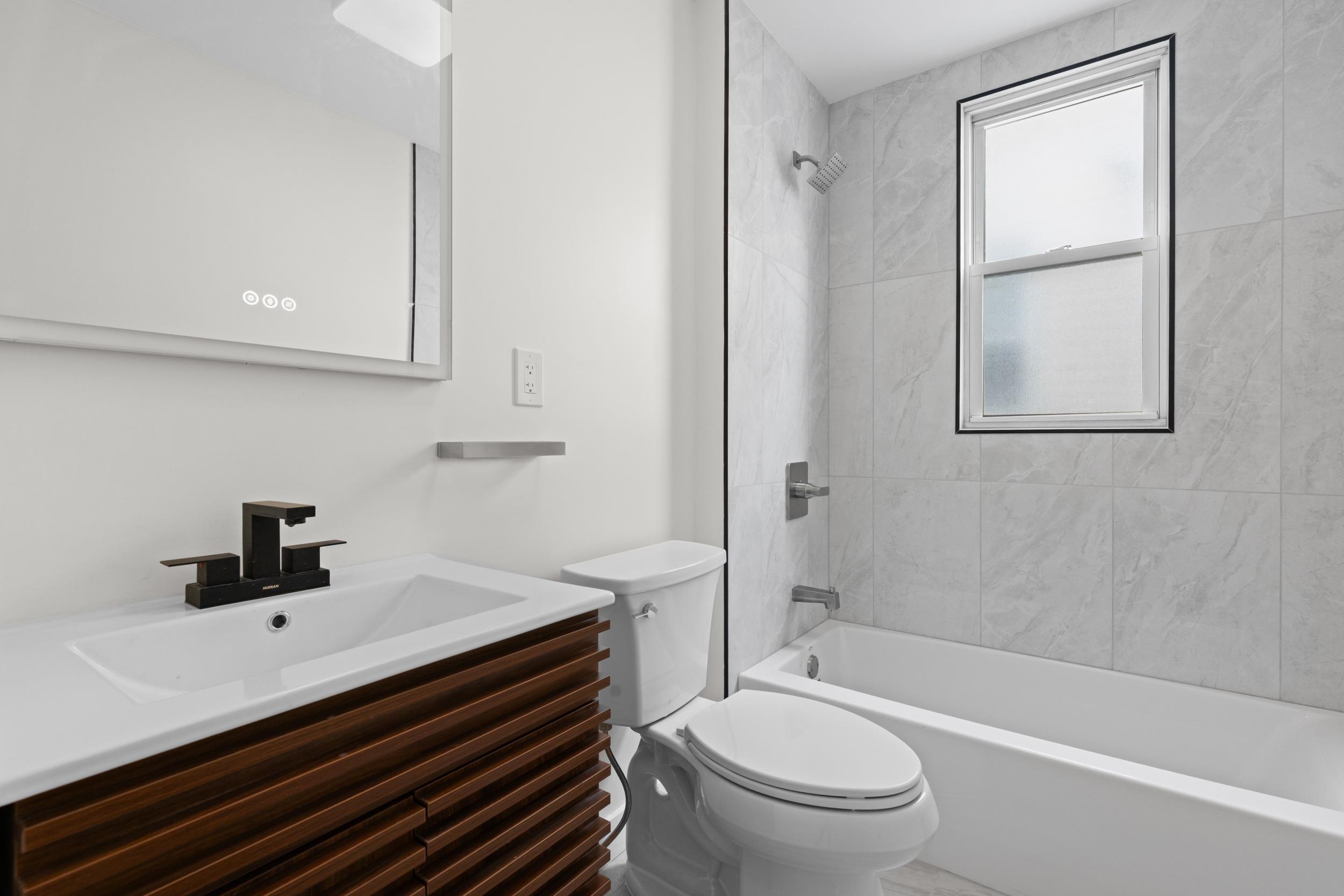 3 Edison Place, Unit 1 East Rutherford, NJ 07073 - Photo 7 of 21 a bathroom with a sink a toilet and shower