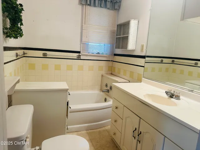 a bathroom with a sink a toilet and bathtub