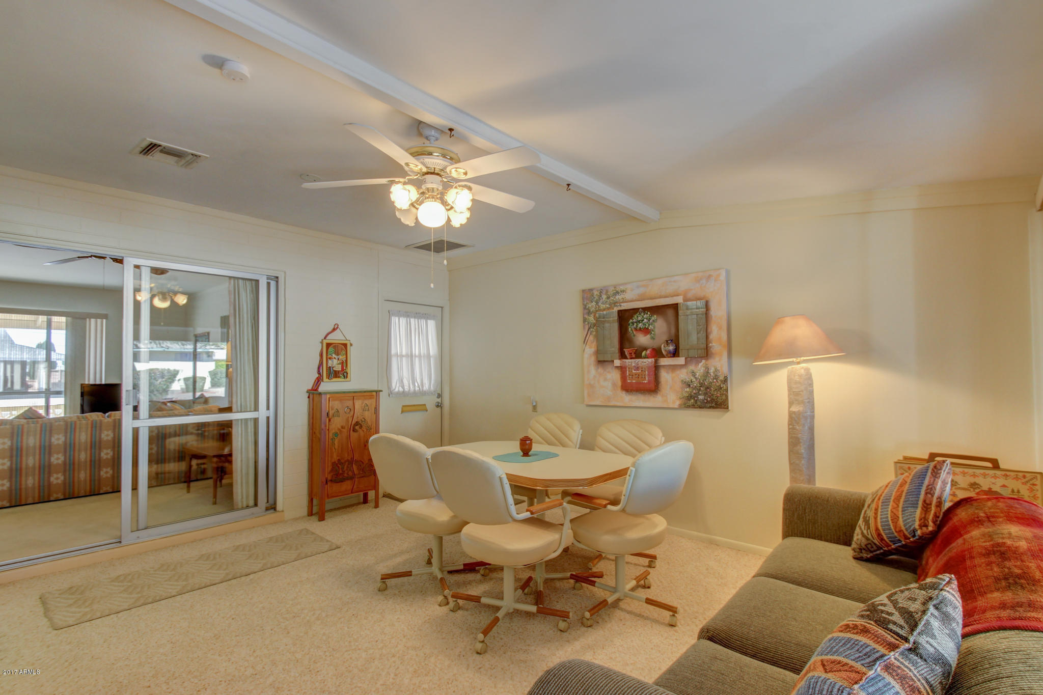 10008 West Riviera Drive Sun City, AZ 85351 - Photo 17 of 26 a living room with furniture and a chandelier