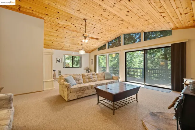 a living room with furniture and a floor to ceiling window