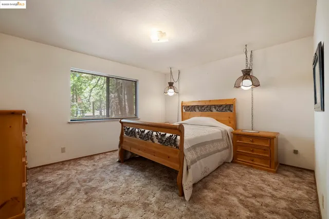 a bedroom with a bed and window