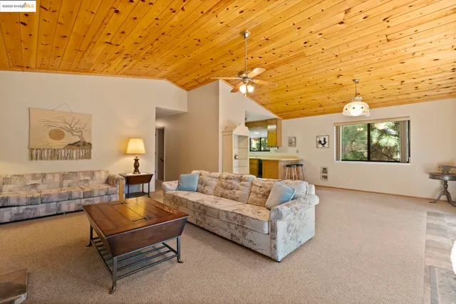 a living room with furniture and a wall painting