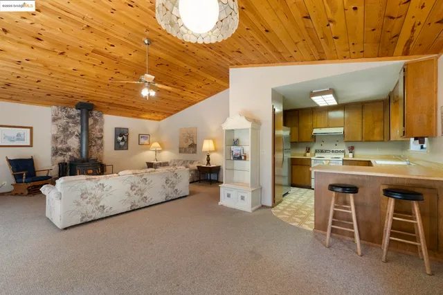 a spacious bedroom with a bed a table and chair