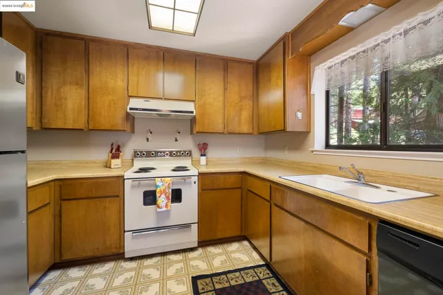 a kitchen with a stove sink and cabinets