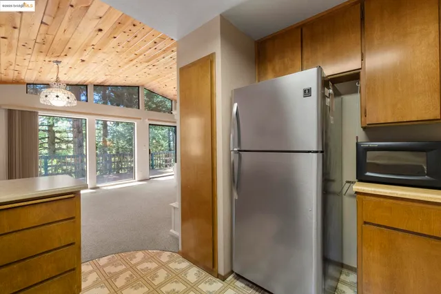 a kitchen with stainless steel appliances a refrigerator and a window