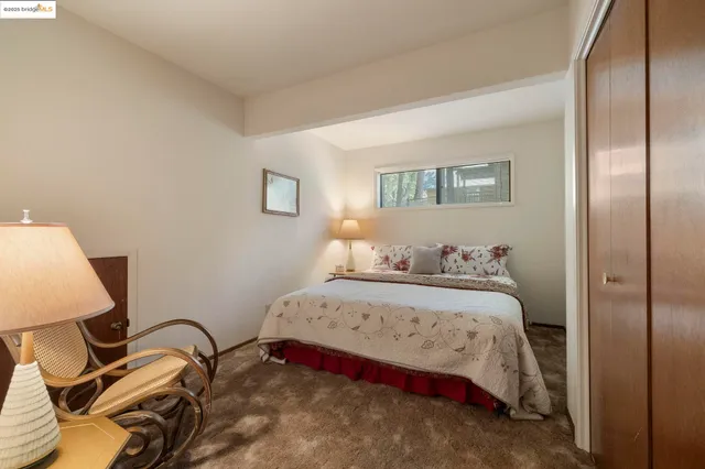 a bedroom with a bed and a lamp on table