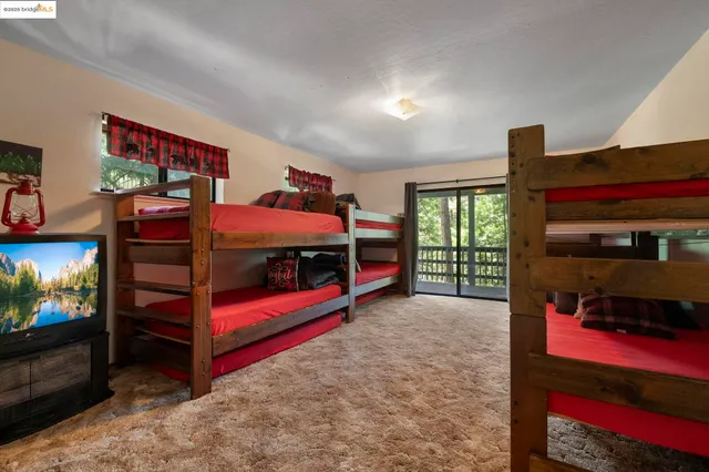 a bedroom with furniture and a flat screen tv