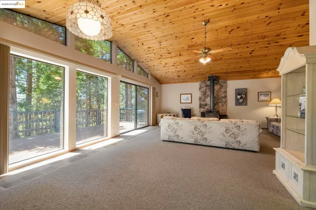 a living room with furniture and large windows