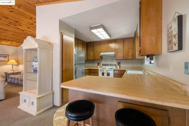 a kitchen with a refrigerator a stove and a cabinets