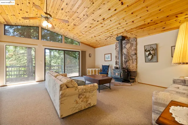 a living room with furniture and large windows