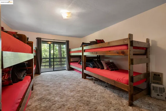 a bedroom with a bed and a tv