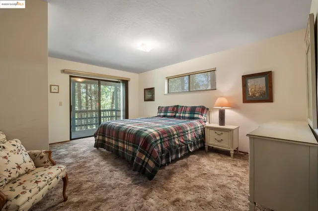 a spacious bedroom with a bed and a couch