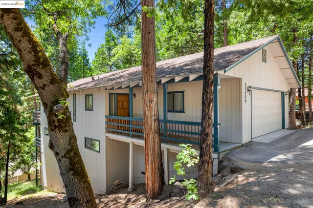 a view of a house with a tree beside it