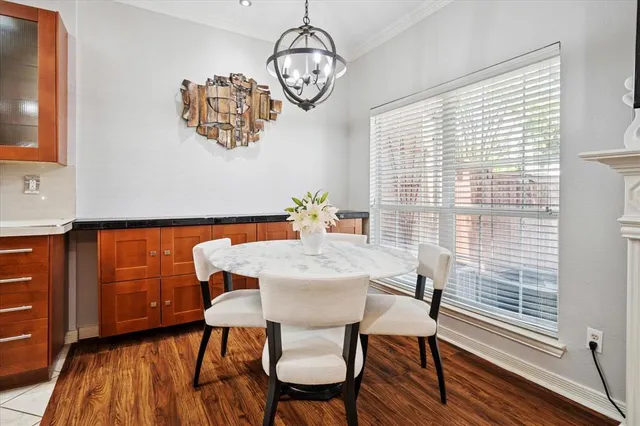a view of a dining room with furniture wooden floor and chandelier