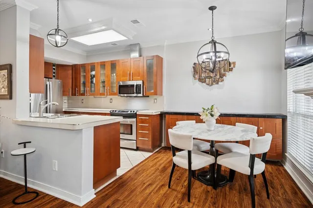 a kitchen with a sink refrigerator and cabinets
