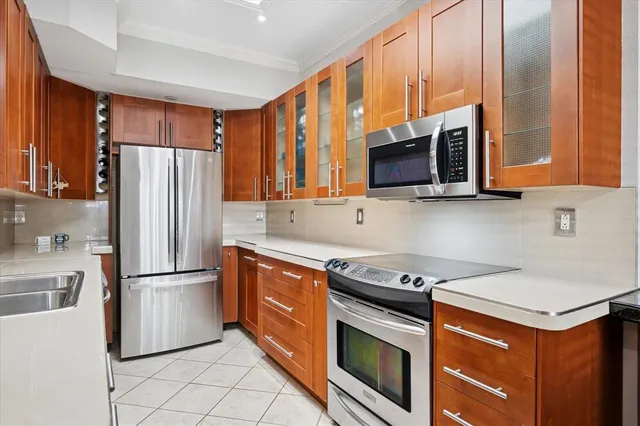 a kitchen with stainless steel appliances granite countertop a sink stove and refrigerator