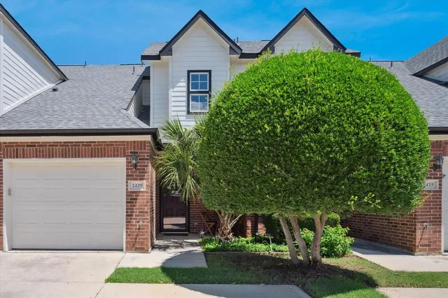 a front view of a house with a yard garage and outdoor seating