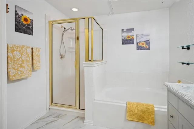 a bathroom with a granite countertop sink a mirror and shower