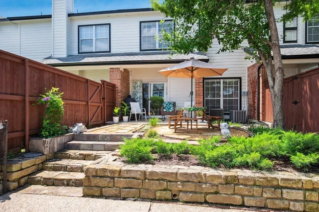 a patio with a patio table and chairs