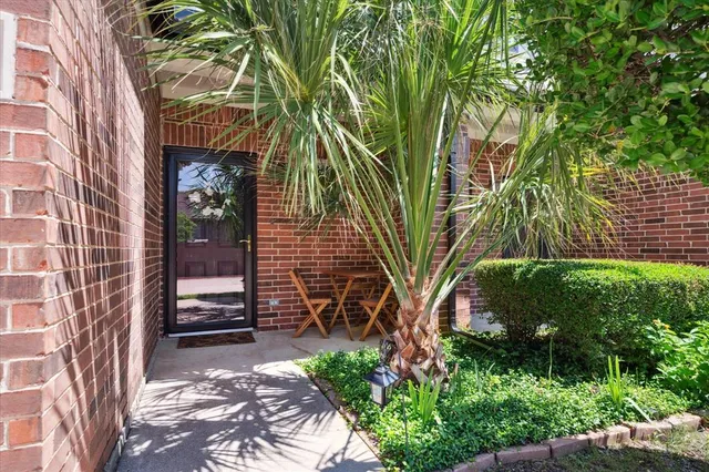 a view of backyard with plants and outdoor seating