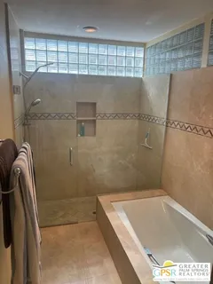 a bathroom with a tub and shower