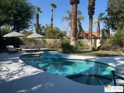 a view of a swimming pool with a patio