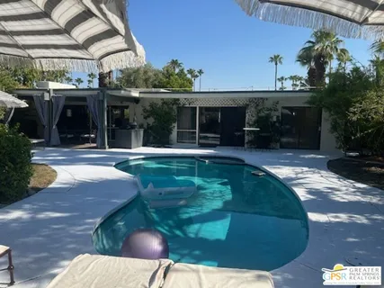 a swimming pool with patio outdoor seating and yard
