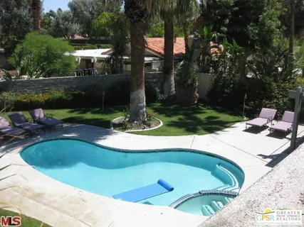 a view of a swimming pool with a yard