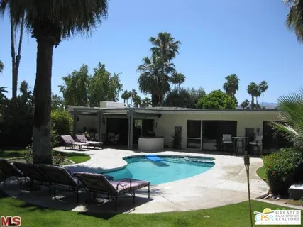 a view of house with swimming pool outdoor seating area and furniture
