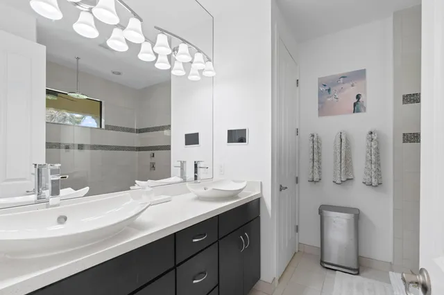 a bathroom with a sink a toilet and mirror