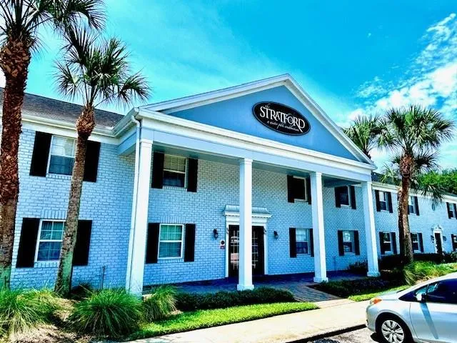 a view of a white house with a yard and plants