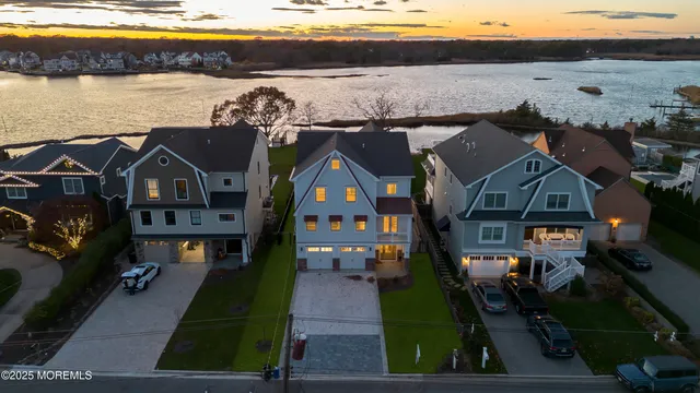 an aerial view of houses with a lake