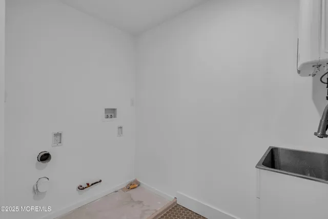 an empty room with wooden floor and window