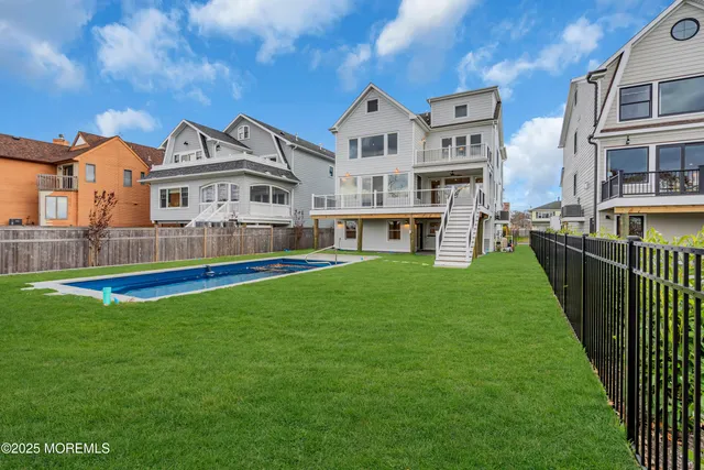 a view of a house with a yard and sitting area