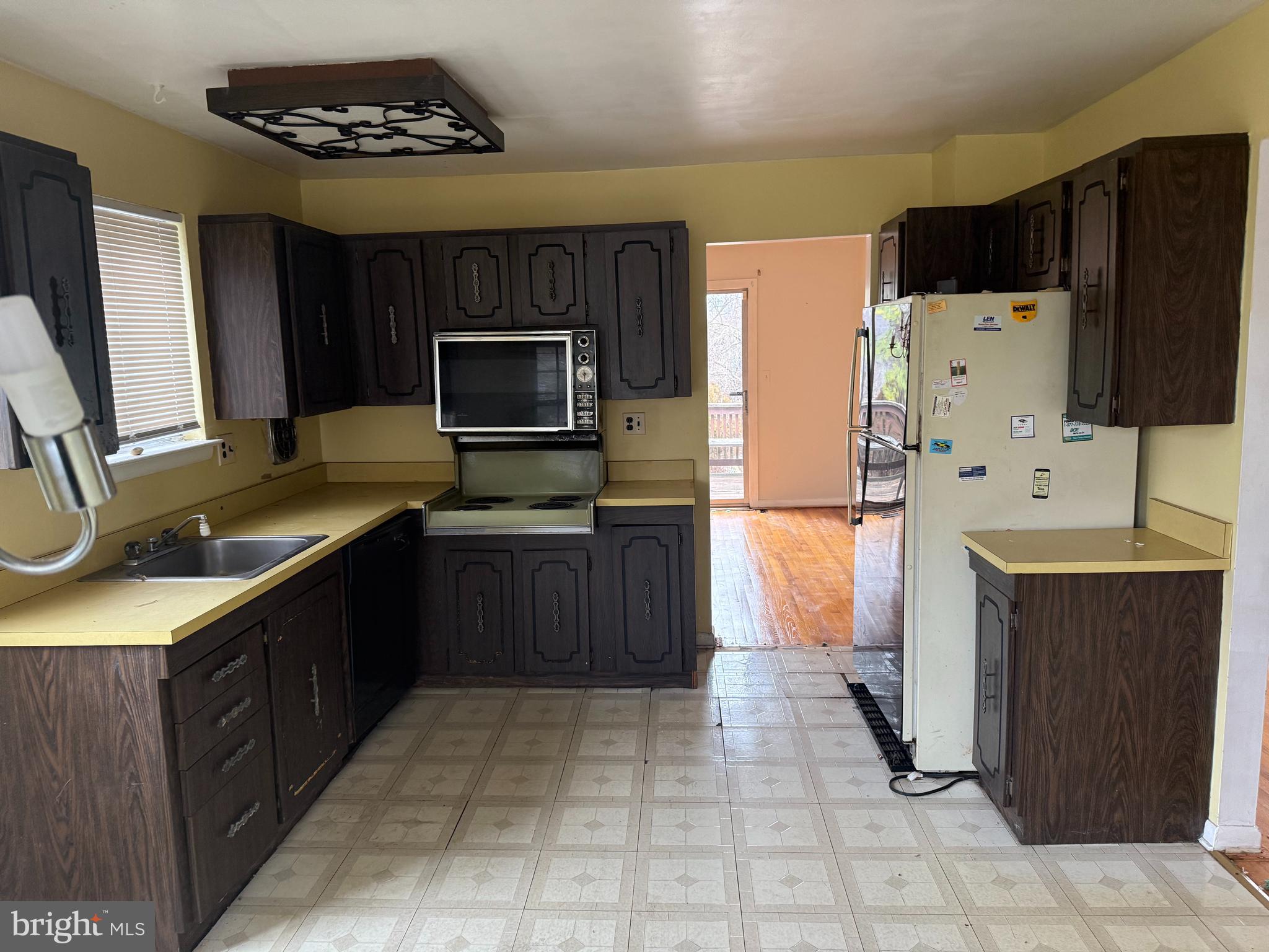 9822 Clanford Road Randallstown, MD 21133 - Photo 4 of 15 a kitchen with stainless steel appliances a refrigerator stove microwave and sink