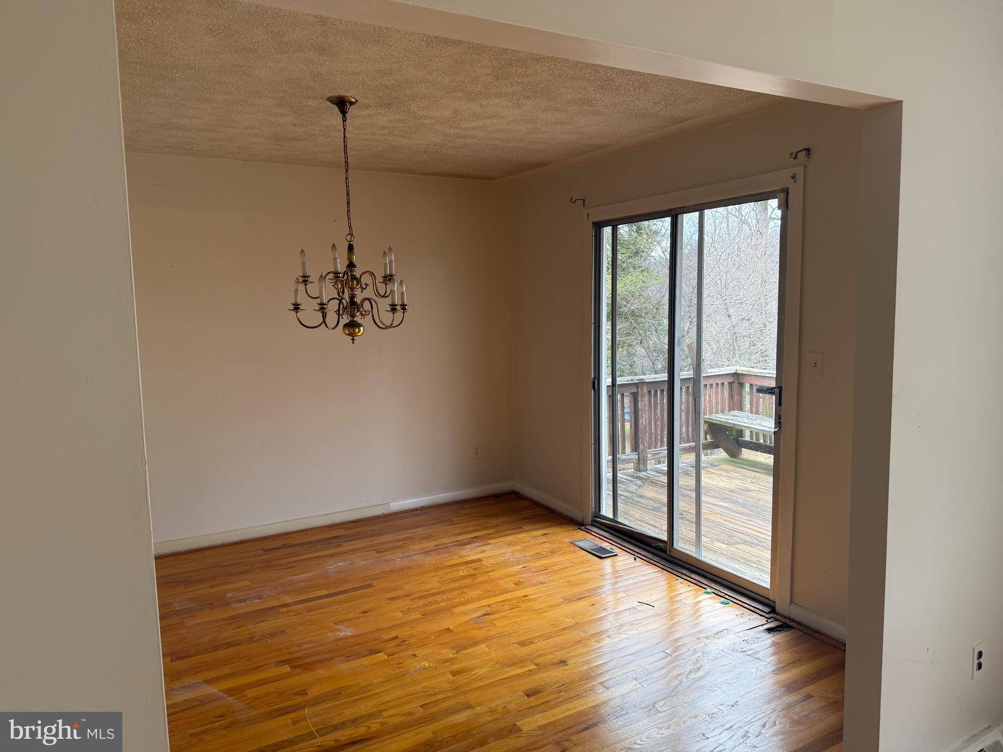 9822 Clanford Road Randallstown, MD 21133 - Photo 5 of 15 a view of an empty room with glass door