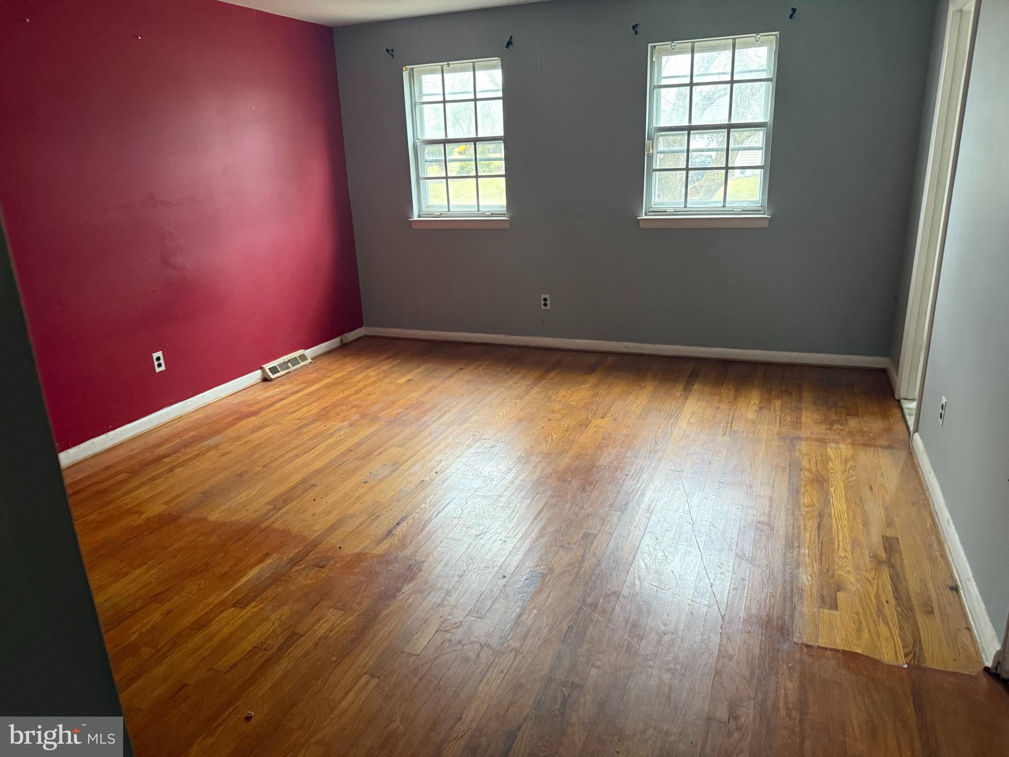 9822 Clanford Road Randallstown, MD 21133 - Photo 6 of 15 an empty room with wooden floor and windows