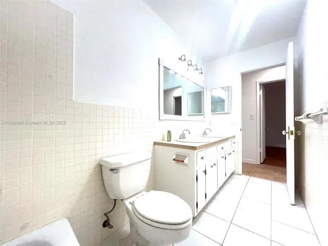 an empty room with wooden floor and chandelier fan