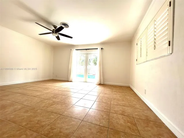 a view of a livingroom with a ceiling fan and window