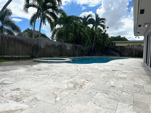 a view of a house with pool table and chairs