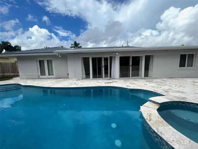 a view of a swimming pool with a yard