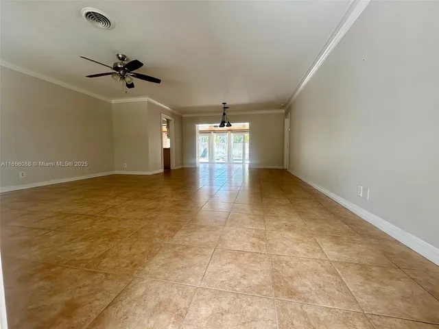 an empty room with windows and ceiling fan view